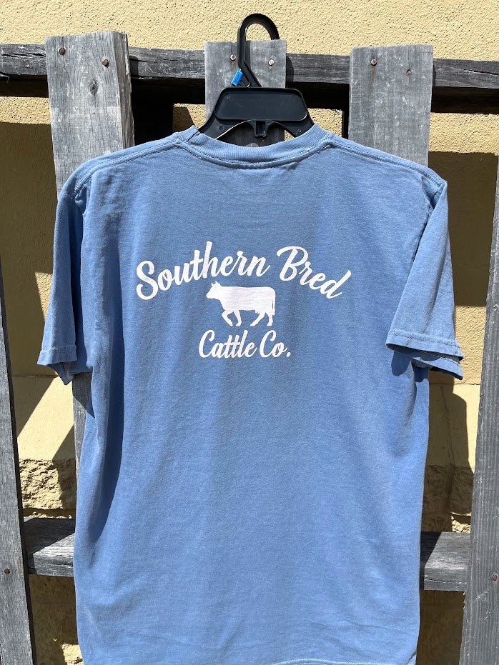Blue Jean t-shirt with 'Southern Bred Cattle Co.' White text and cow graphic on a wooden background