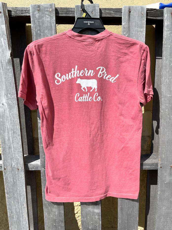 Brick t-shirt with 'Southern Bred Cattle Co.' text and cow graphic on a wooden fence.