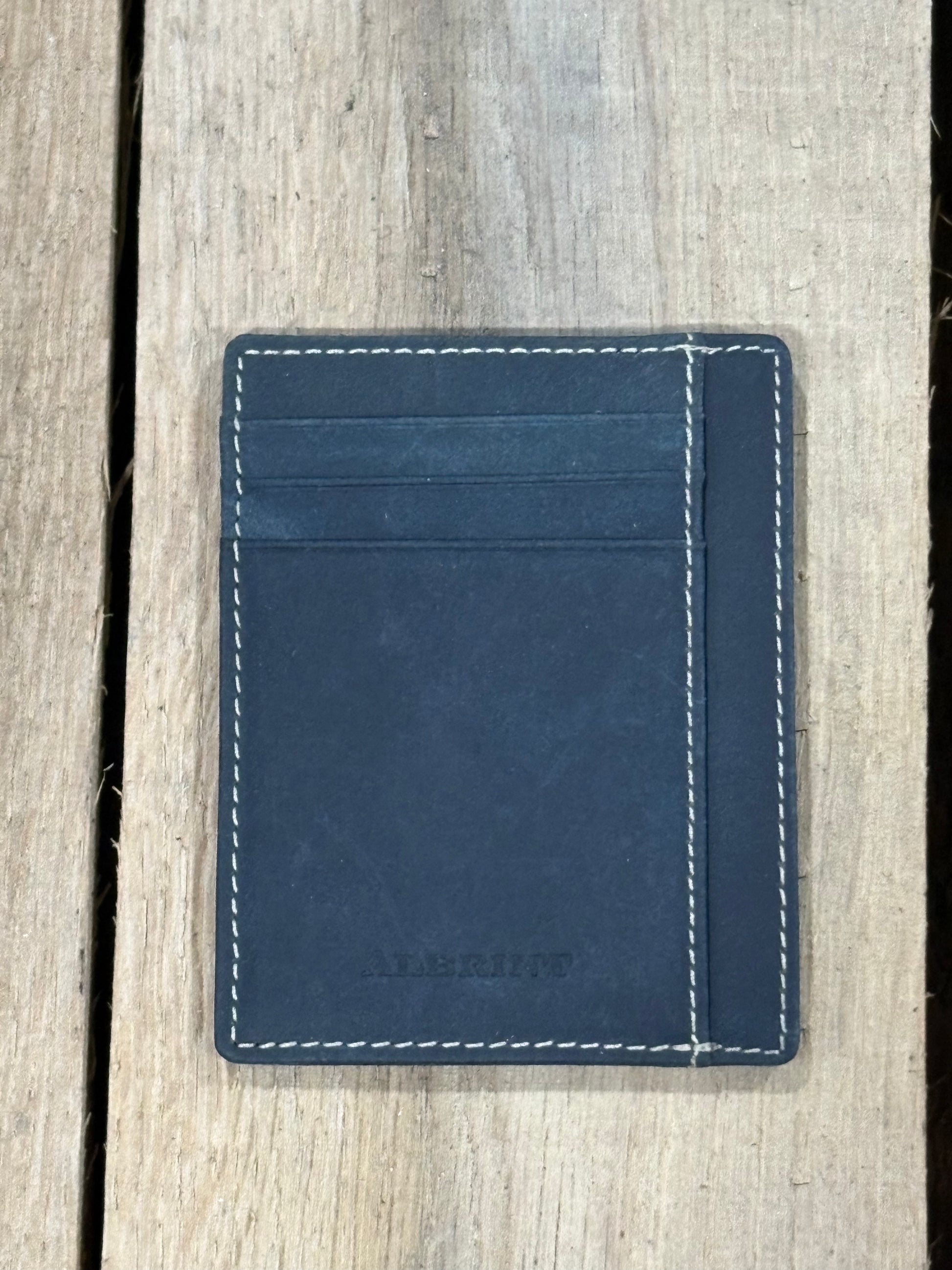 Black leather cardholder with white stitching on a wooden surface