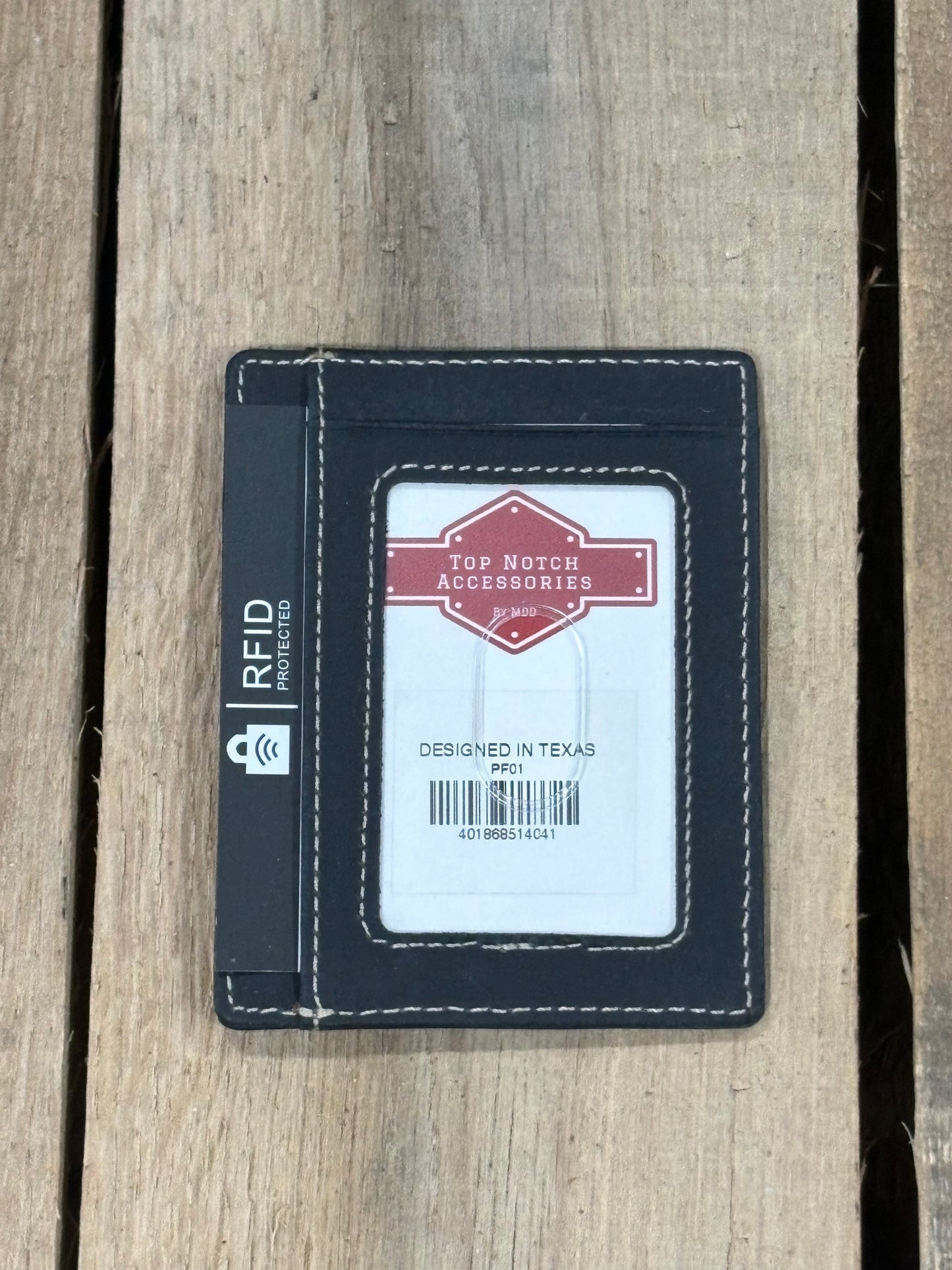 Black cardholder with 'Top Notch Accessories' branding on a wooden surface