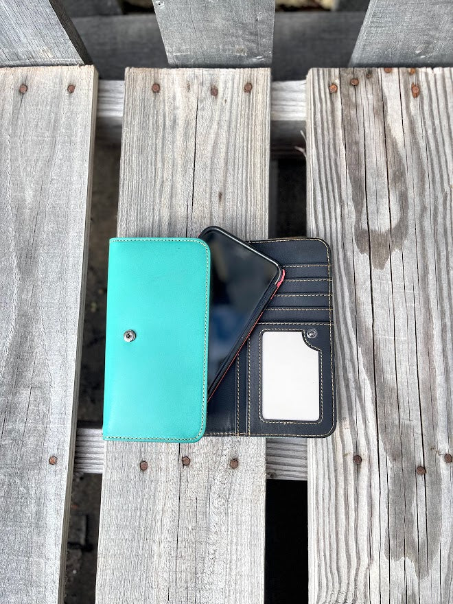 Inside view of a turquoise phone case, on a wooden surface.