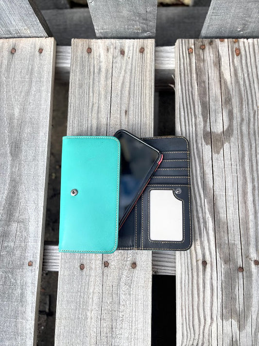 Inside view of a turquoise phone case, on a wooden surface.