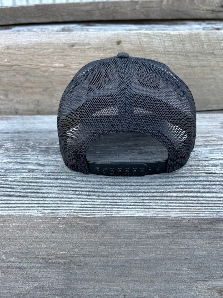 Black mesh cap on a wooden surface