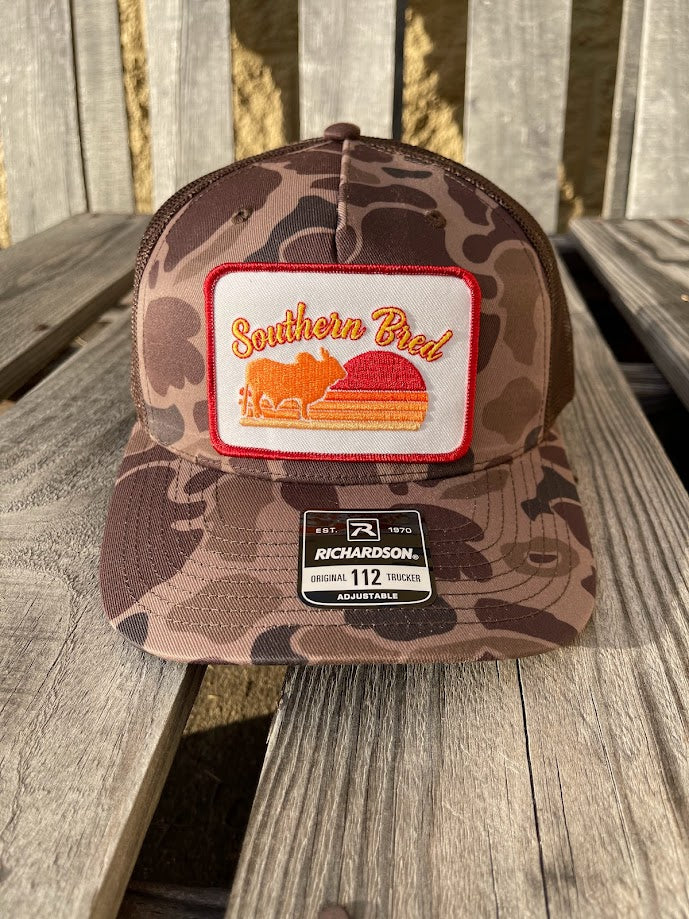 Camouflage cap with a patch on a wooden surface