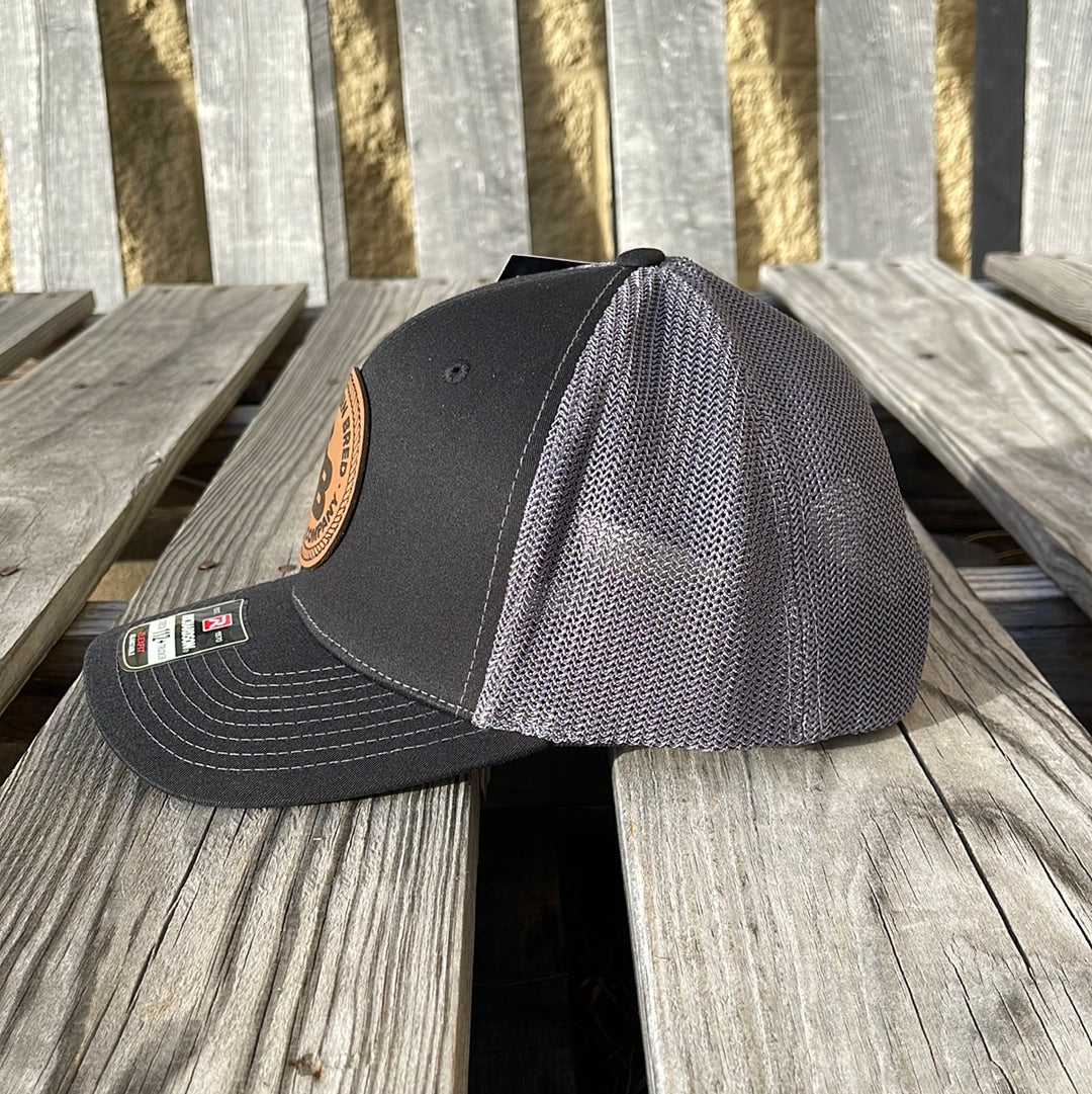 Black and gray baseball cap on a wooden surface