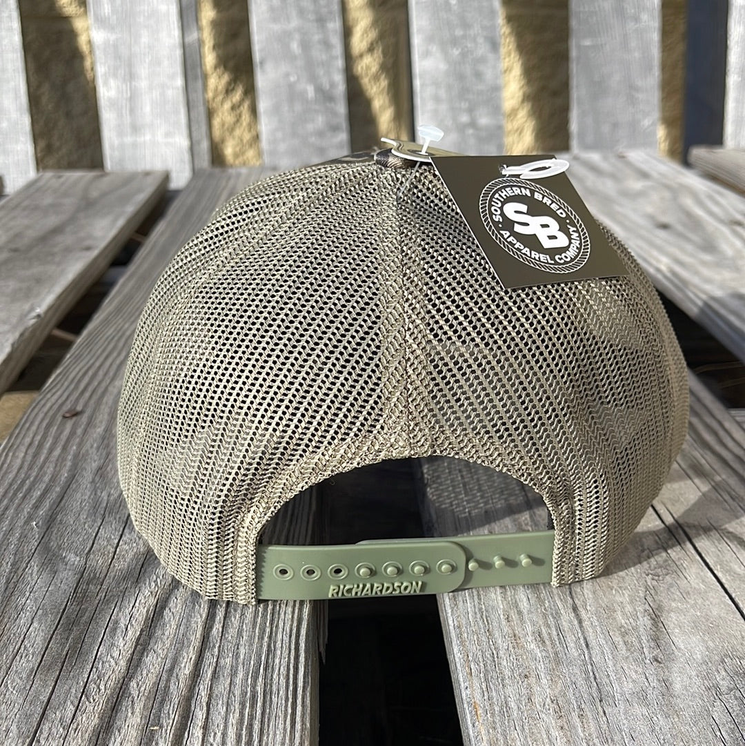 Mesh back cap with Richardson branding on a wooden surface