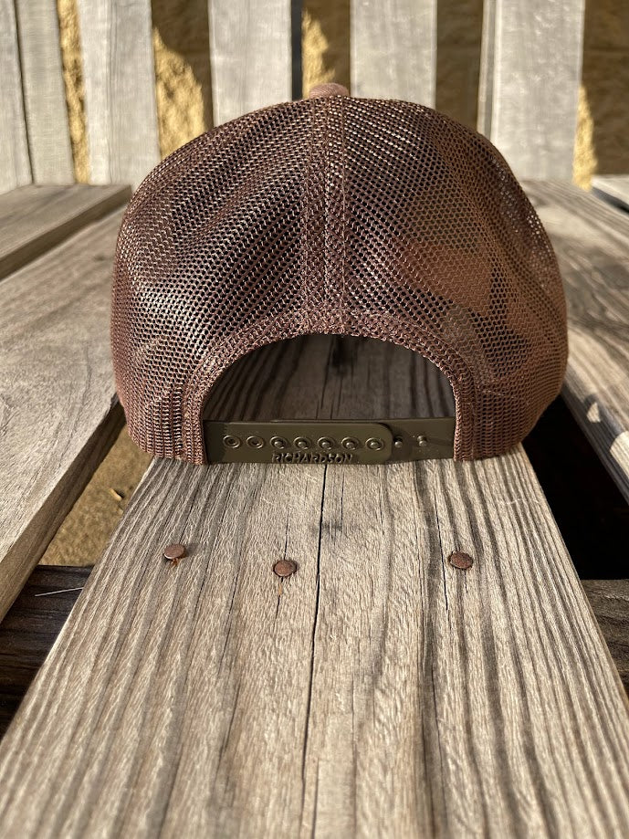 Brown mesh cap on a wooden surface