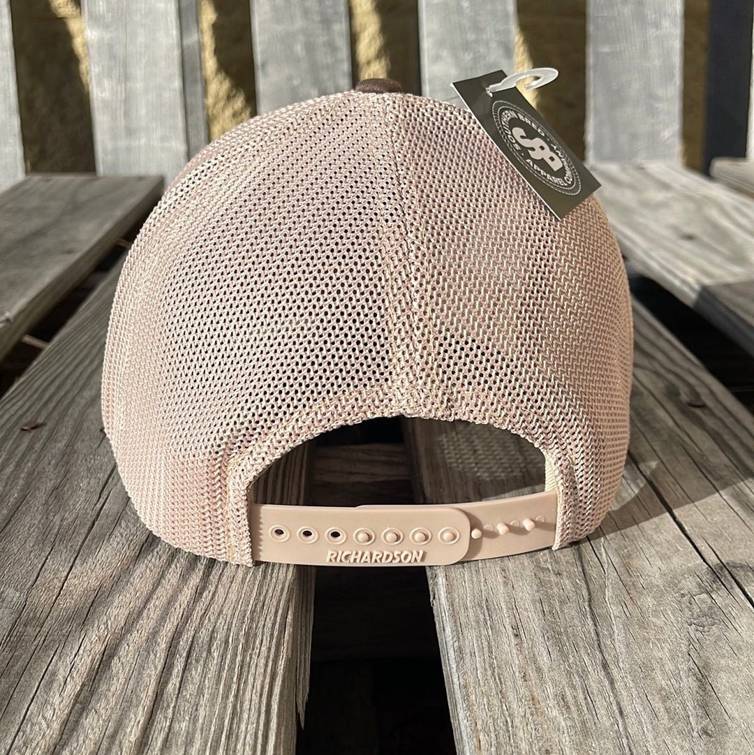 Beige mesh cap with Richardson logo on a wooden surface