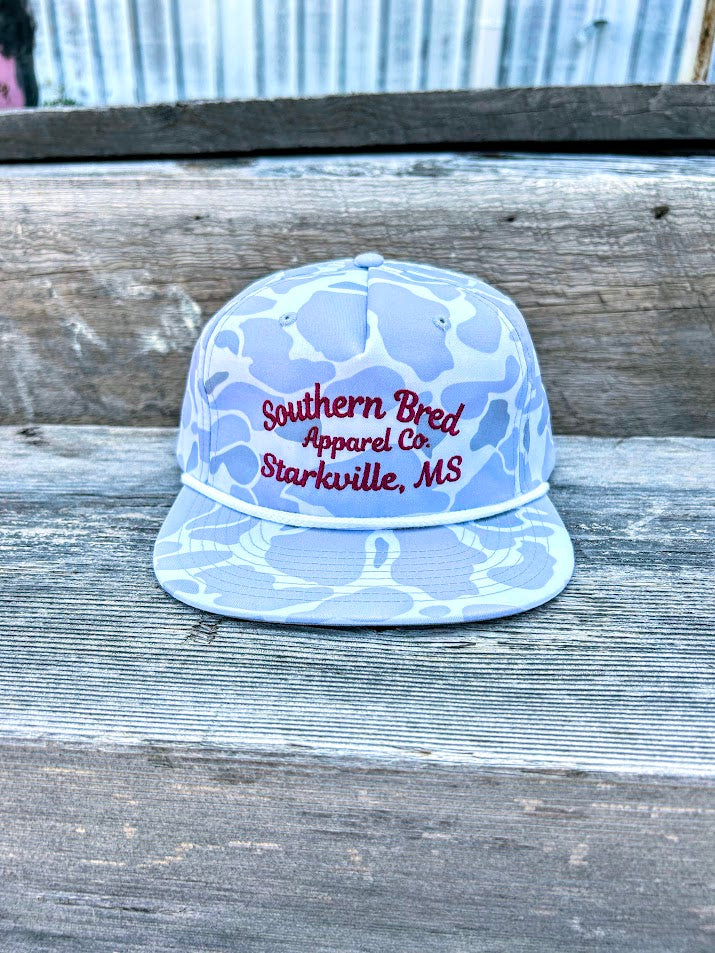 Light blue cap with red text on a wooden surface