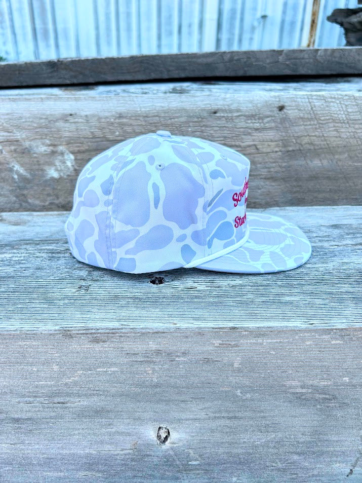 White cap with blue pattern on a wooden surface
