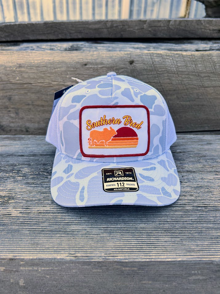 Cap with 'Southern Pride' logo on a wooden surface