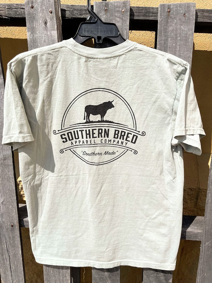 Bay t-shirt with 'Southern Bred Apparel Company' Black logo on a wooden background
