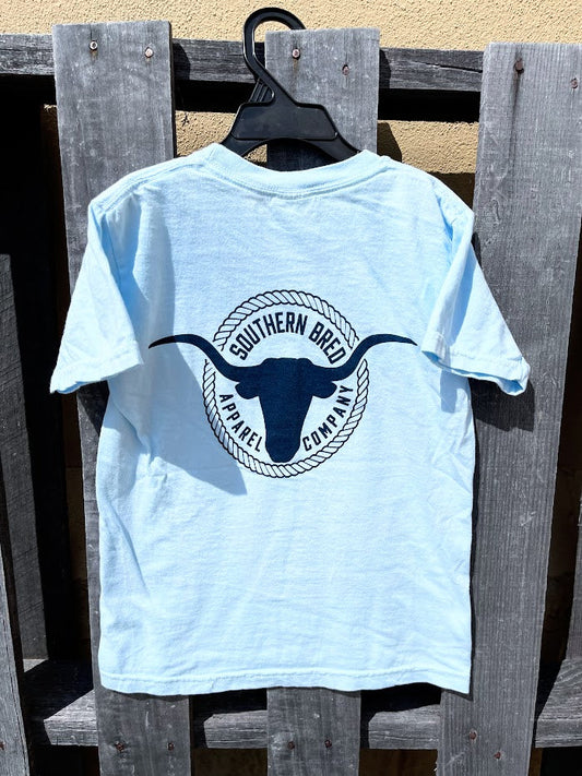 Light blue t-shirt with a logo on a wooden surface